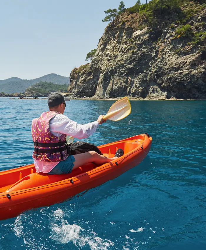 Man kayaking in the ocean